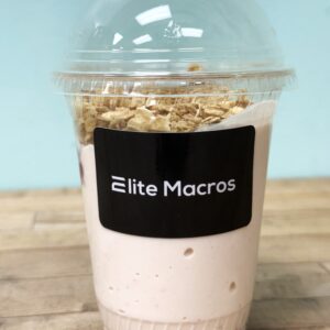 A parfait with granola, blueberries, and strawberries.